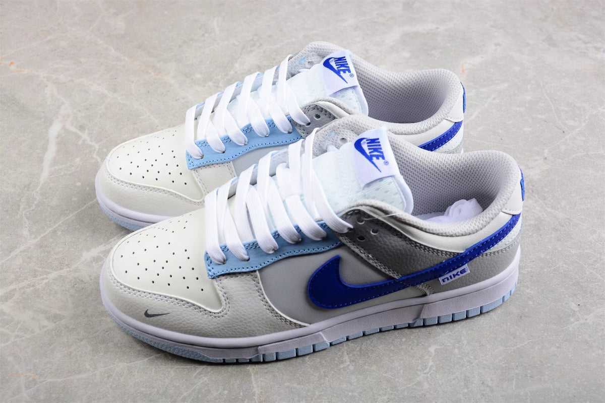 Angled view of the pair showing layered panels, blue side branding, and perforated toe boxes.