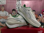 Pair of off-white and green PUMA sneakers, with a visible product tag identifying Reseule Lite Colored Block style 403302 03.