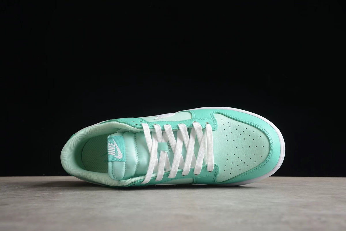 Top-down view of one sneaker showing the perforated toe box, white laces, tongue, and padded collar.