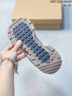 Close view of the patterned rubber outsole on a Nike Zoom Vomero Roam sneaker, with the style code and size range visible above.