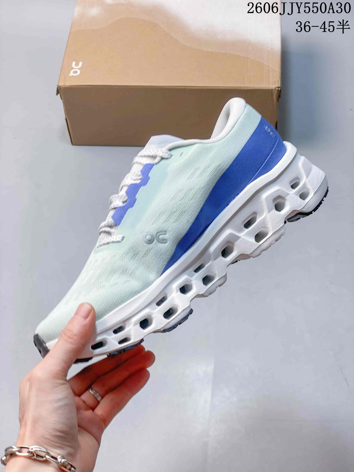 Side view of the pale mint running shoe with blue accents and sculpted midsole