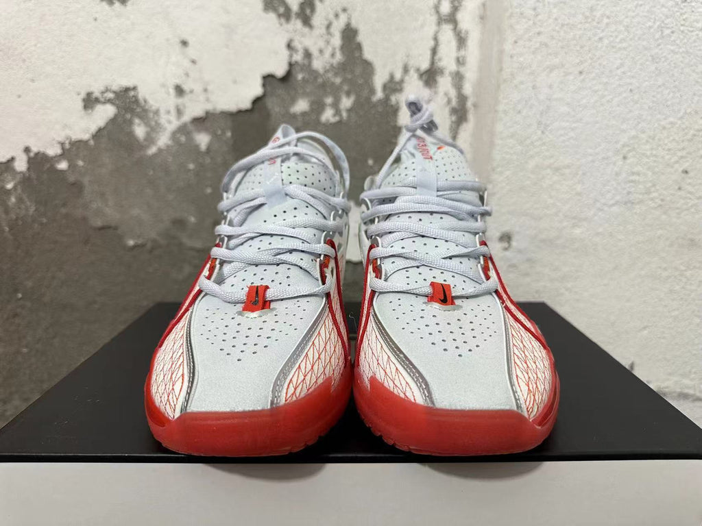 Front view of white and red Nike basketball sneakers with perforated uppers
