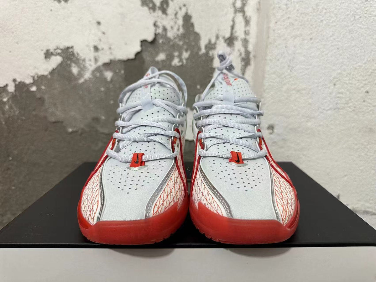 Front view of white and red Nike basketball sneakers with perforated uppers