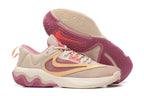 Pale pink and cream basketball shoe with rose-colored details