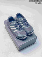 Pair of charcoal gray Adidas Adizero PR sneakers on a shoebox