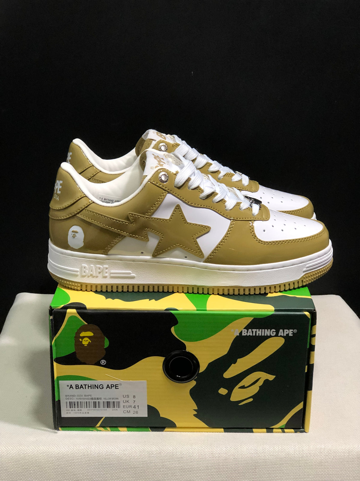 Side view of olive and white BAPE STA sneakers showing the star side panels, white midsoles, and olive outsole edges.
