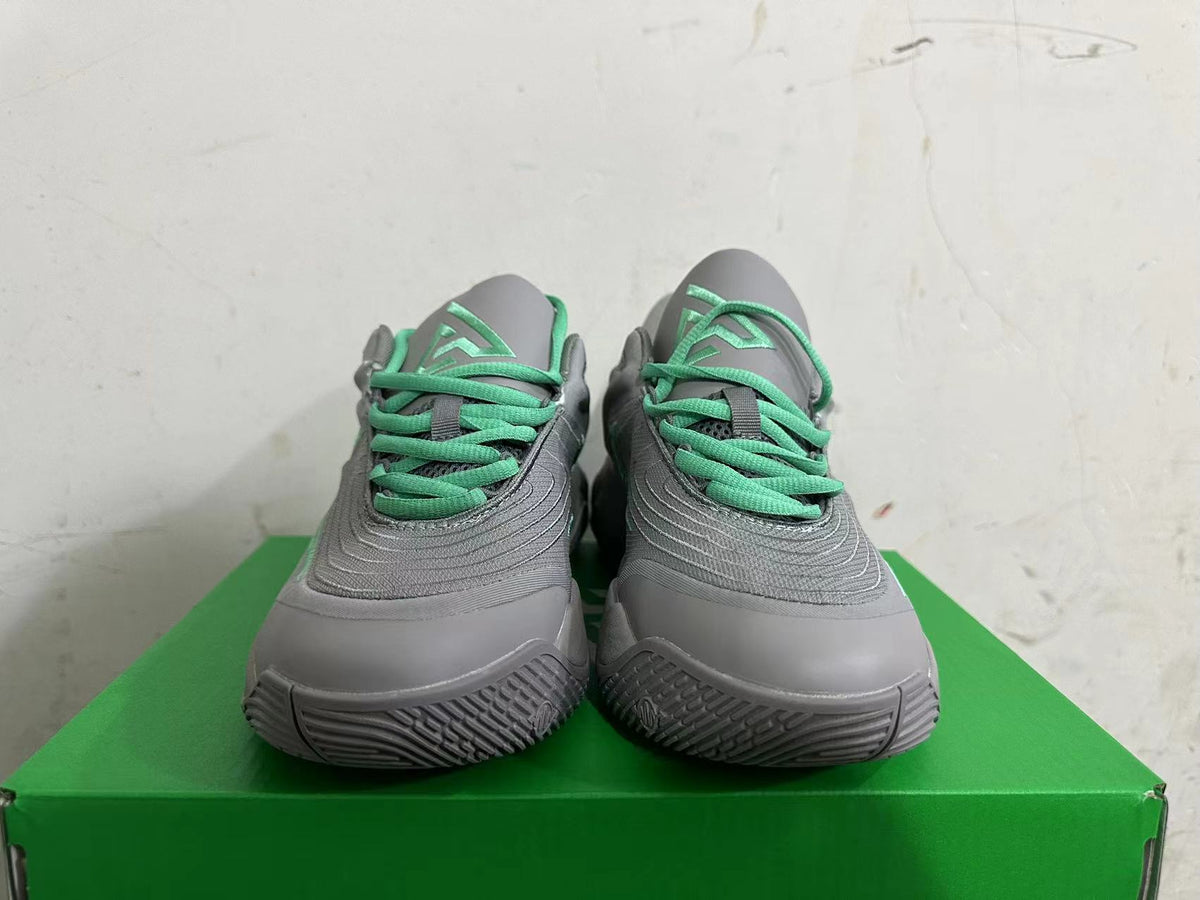 Front view showing green laces and tongue details on grey Nike KD 4 shoes