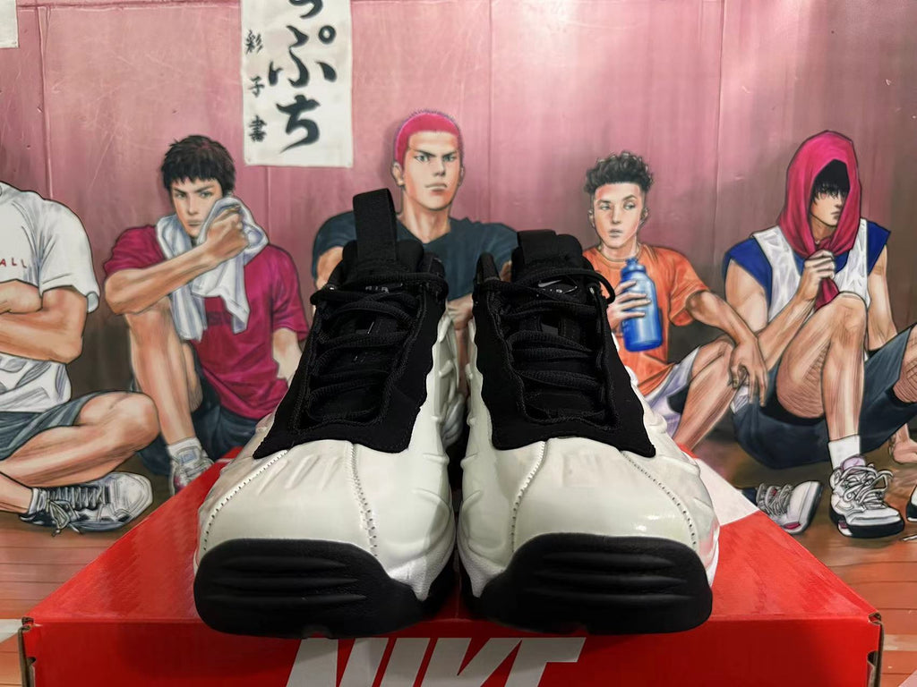 Front view of white and black Nike sneakers with black laces