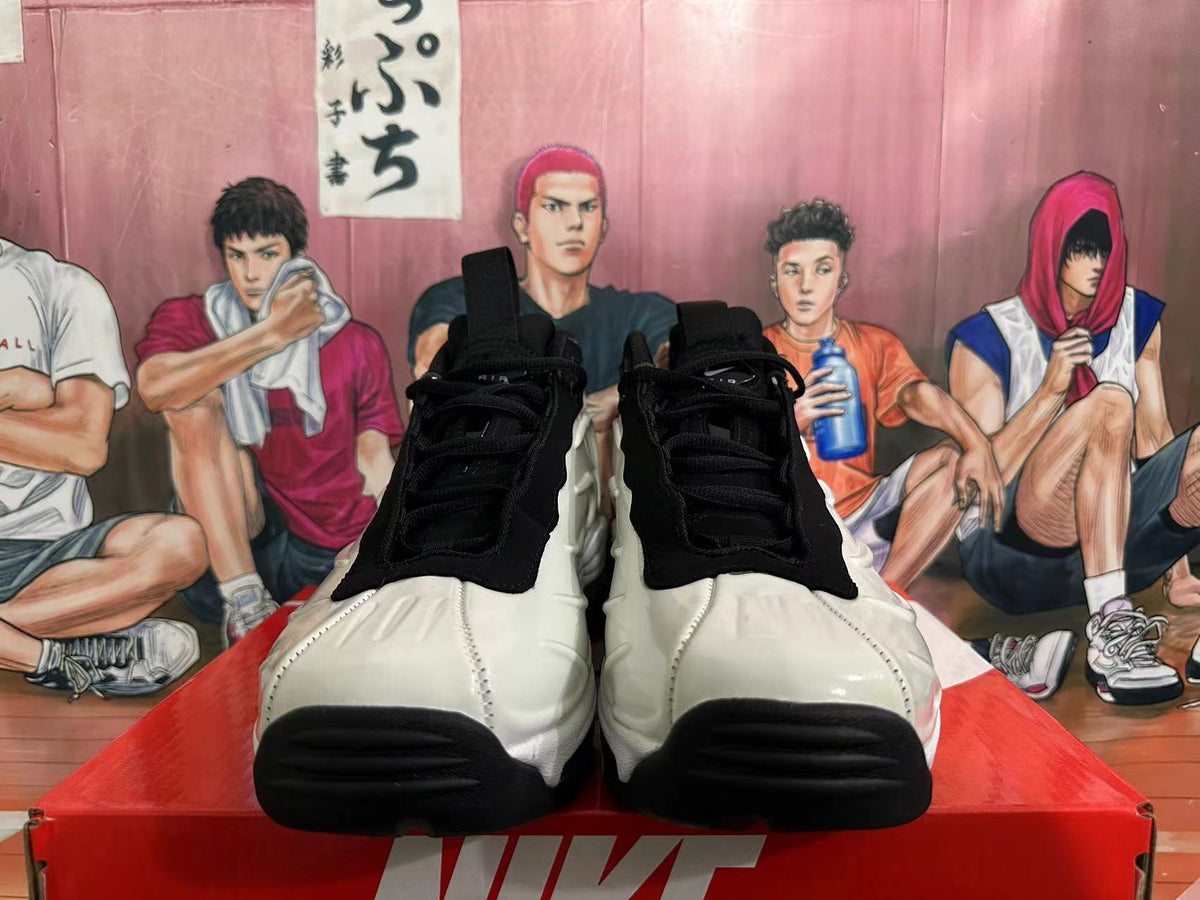 Front view of white and black Nike sneakers with black laces