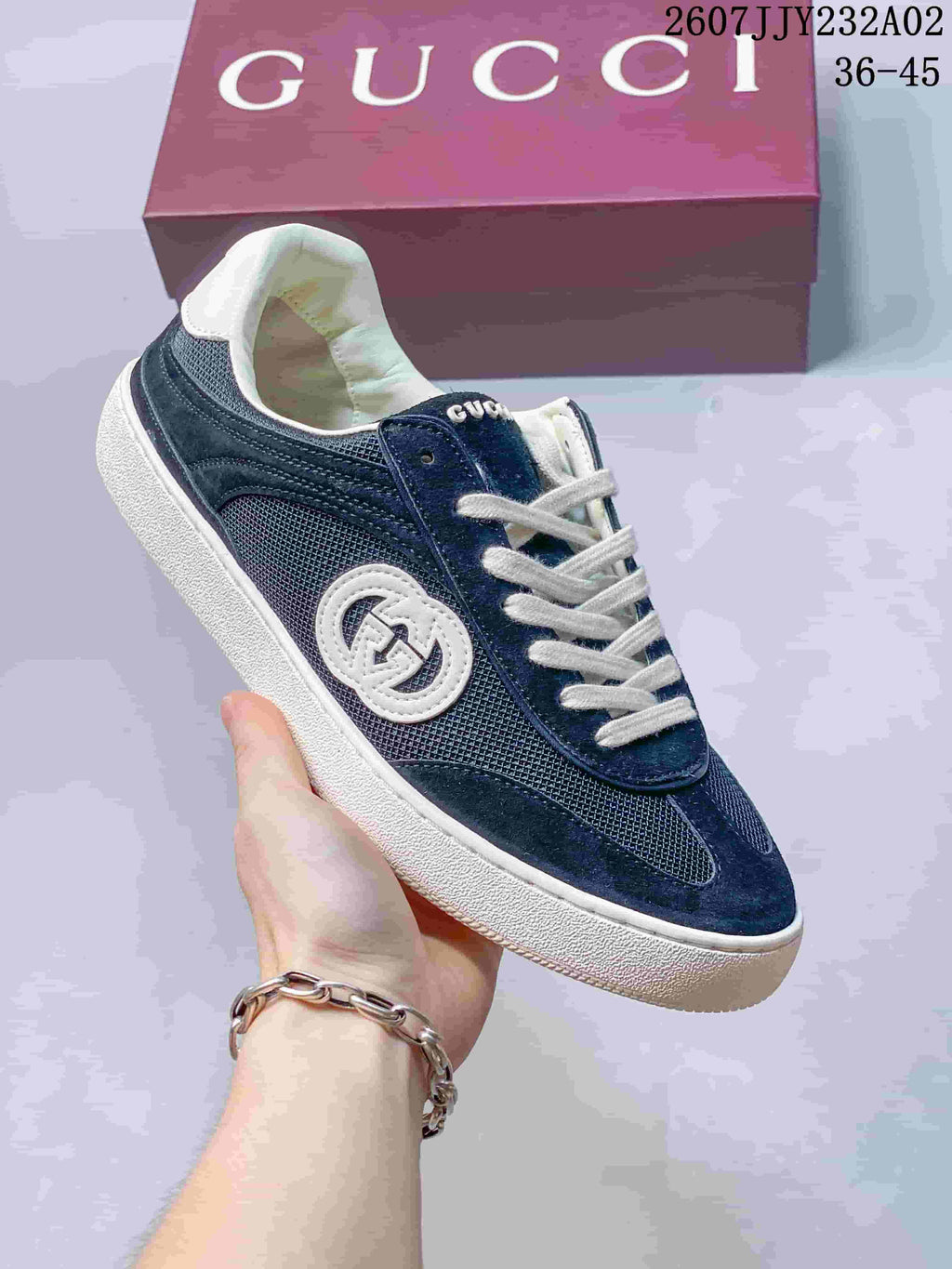 Angled side view of the navy and white low-top sneakers