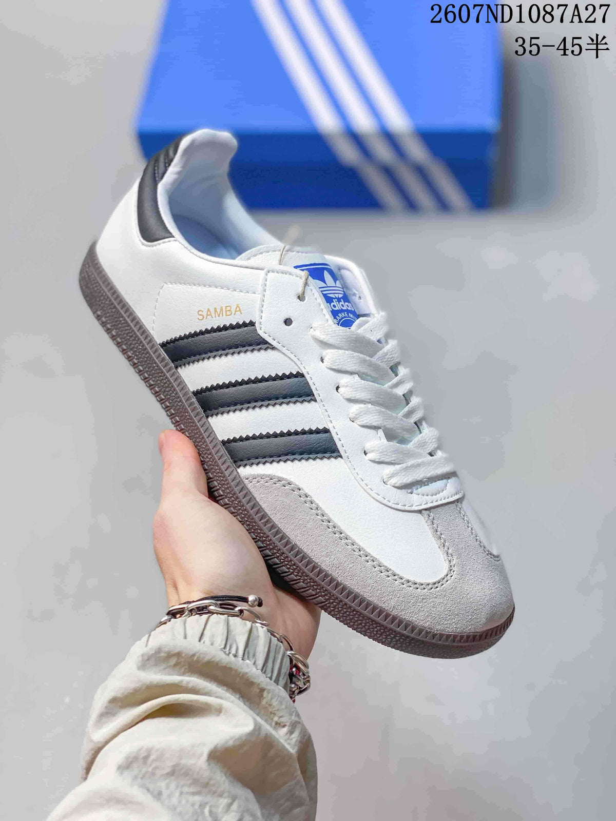 White adidas Samba sneaker with dark stripes, white laces and a gum-look sole.