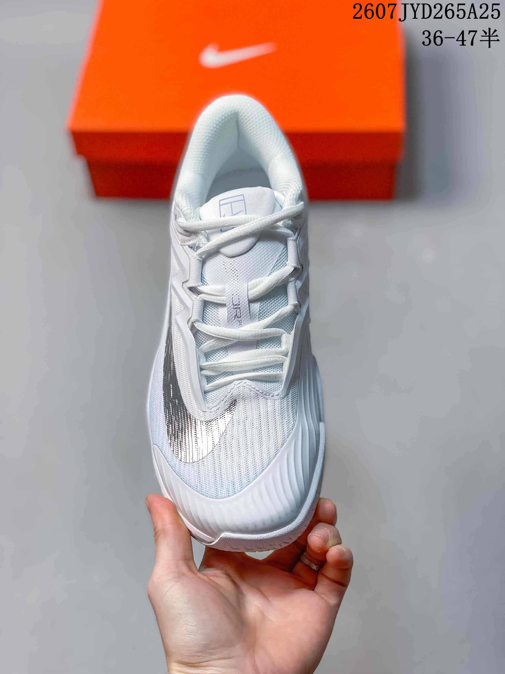 Top-down view of the white lace-up tennis shoe with black side detailing.