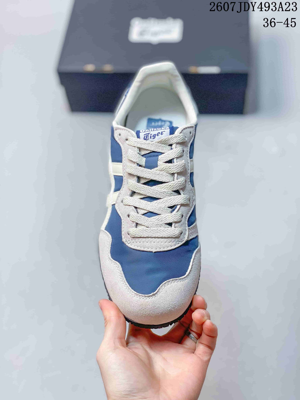 Top view of the blue and white sneaker showing the lace-up design, contrasting overlays and rounded toe.