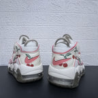 Rear view showing pink heel logos and cherry graphics on the sneakers