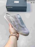 Light gray Onitsuka Tiger Mexico 66 Sabot sneaker held in hand with its box behind it; the image shows style code 2604JDY297A25 and size range 36–45.
