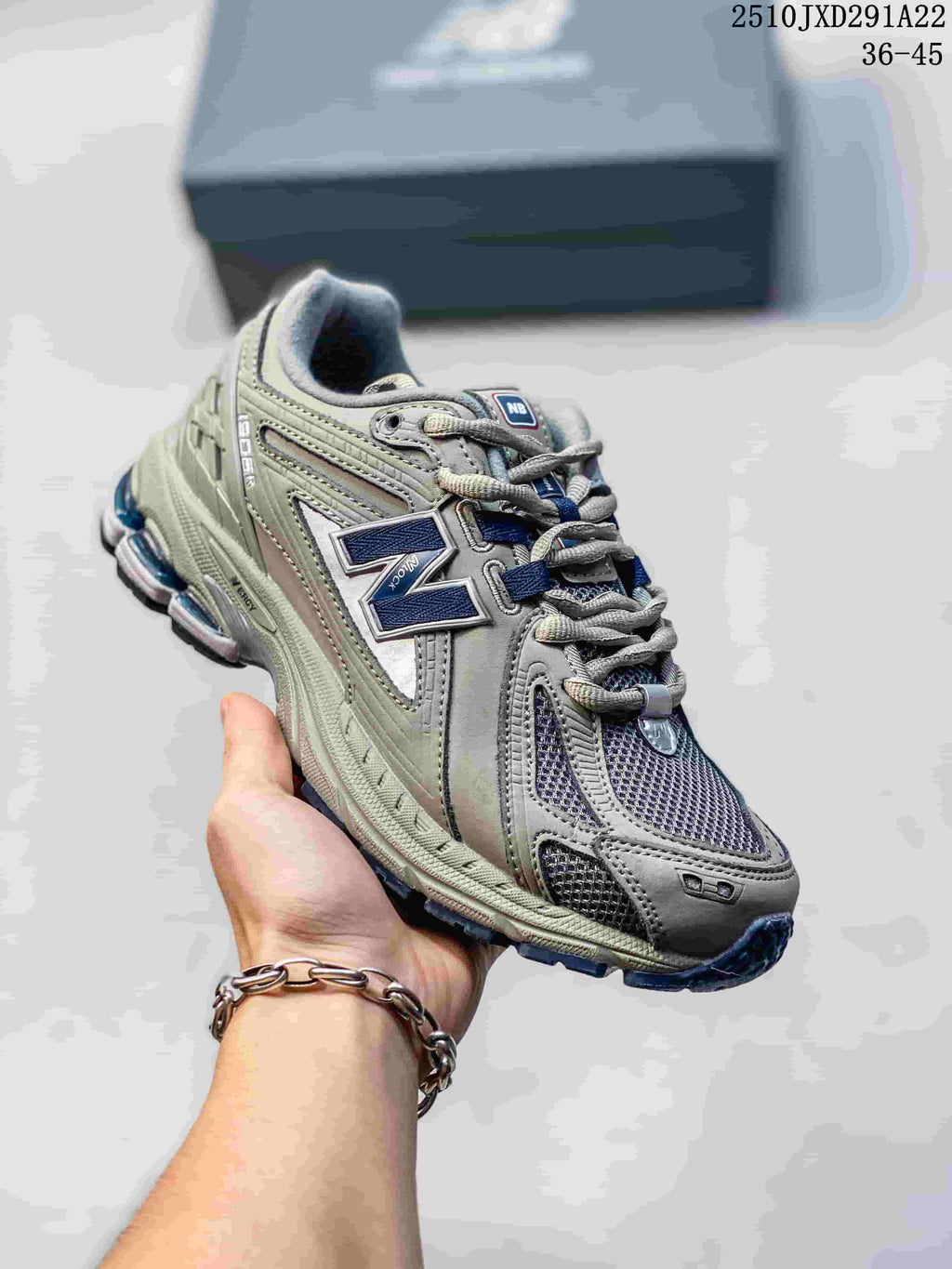 Angled view of a grey and silver New Balance M1906AD sneaker