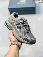 Angled view of a grey and silver New Balance M1906AD sneaker