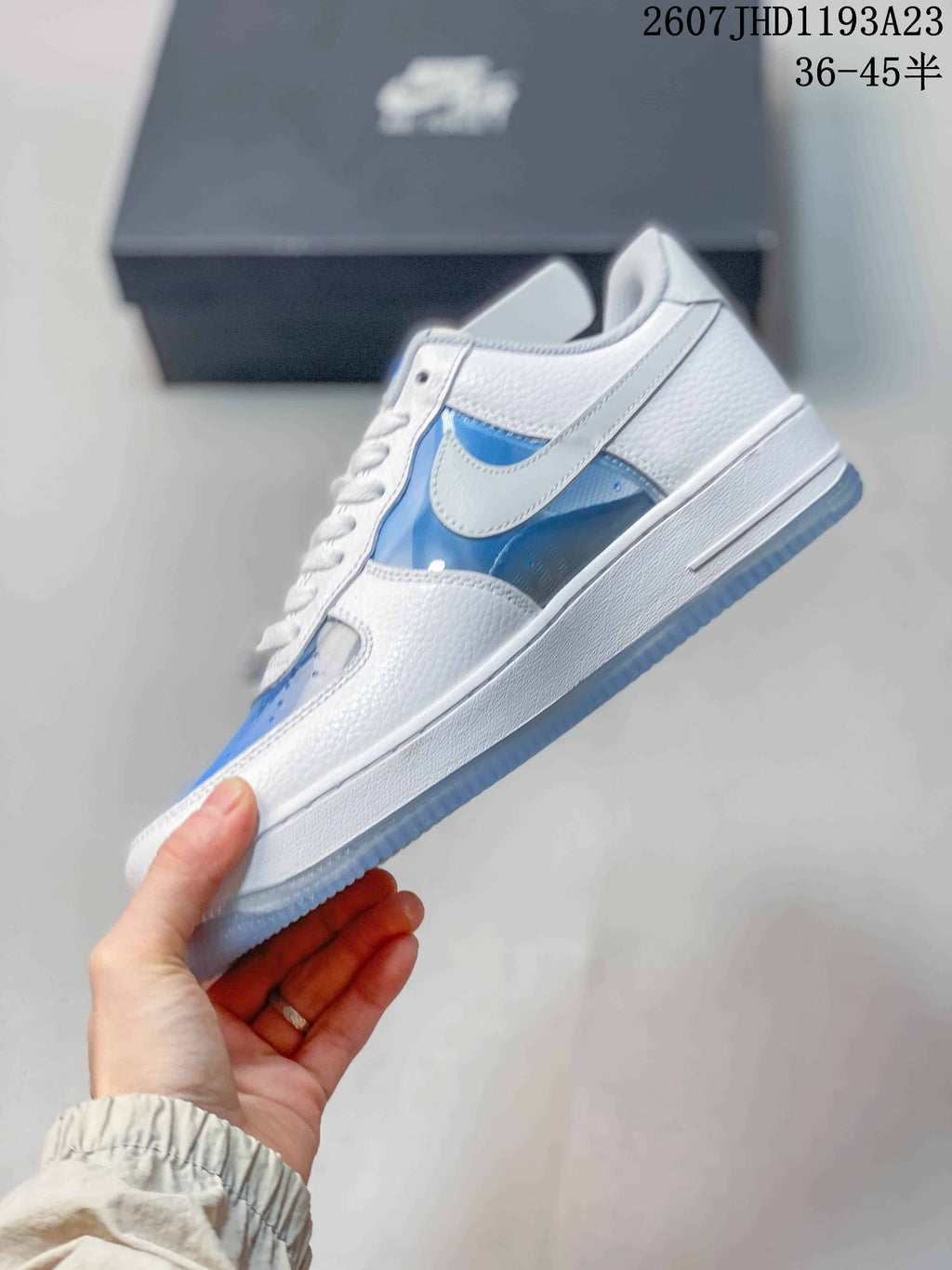 Side view showing the white Swoosh, blue side panels, layered upper, and white midsole.