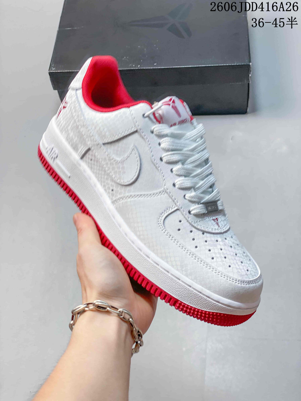 Close view of a white sneaker with red lining and outsole