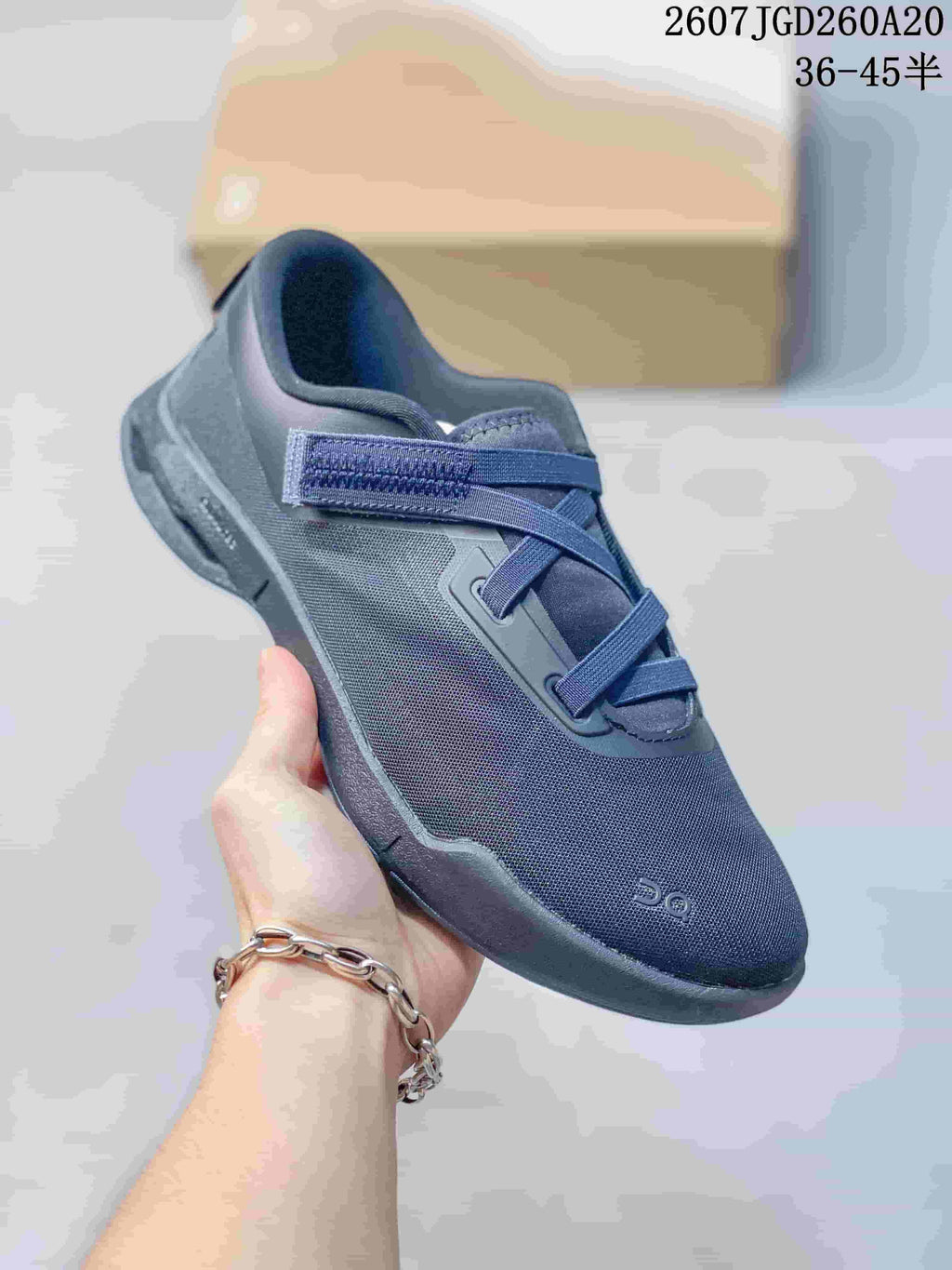 Close side view of a navy On Cloudnova Moon sneaker showing the mesh-style upper, padded collar, strap, and sculpted outsole.