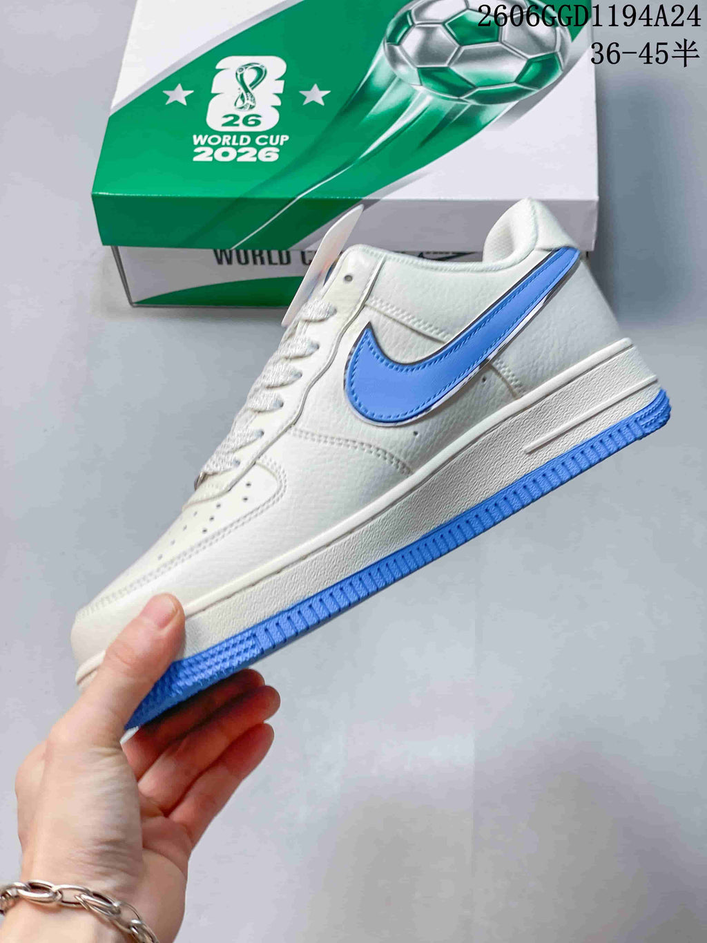 Side view of the white low-top sneaker with blue Swoosh and blue outsole.