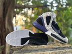 Side view alongside the patterned outsole with black and light grey tread sections