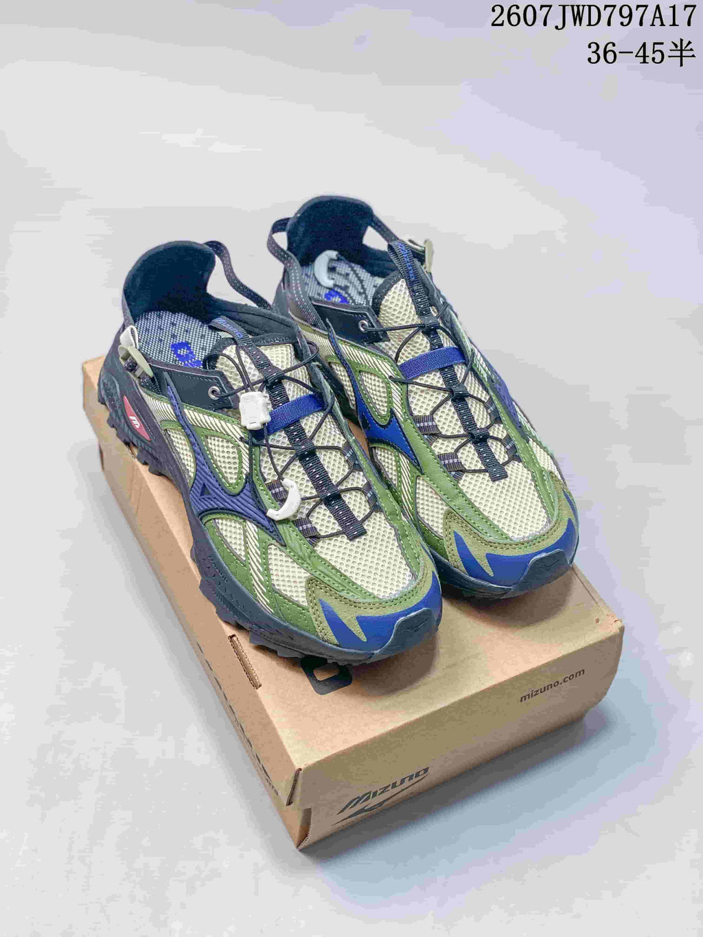 Pair of green, navy, gray, and cream Mizuno sneakers displayed on a Mizuno shoebox.