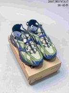 Pair of green, navy, gray, and cream Mizuno sneakers displayed on a Mizuno shoebox.
