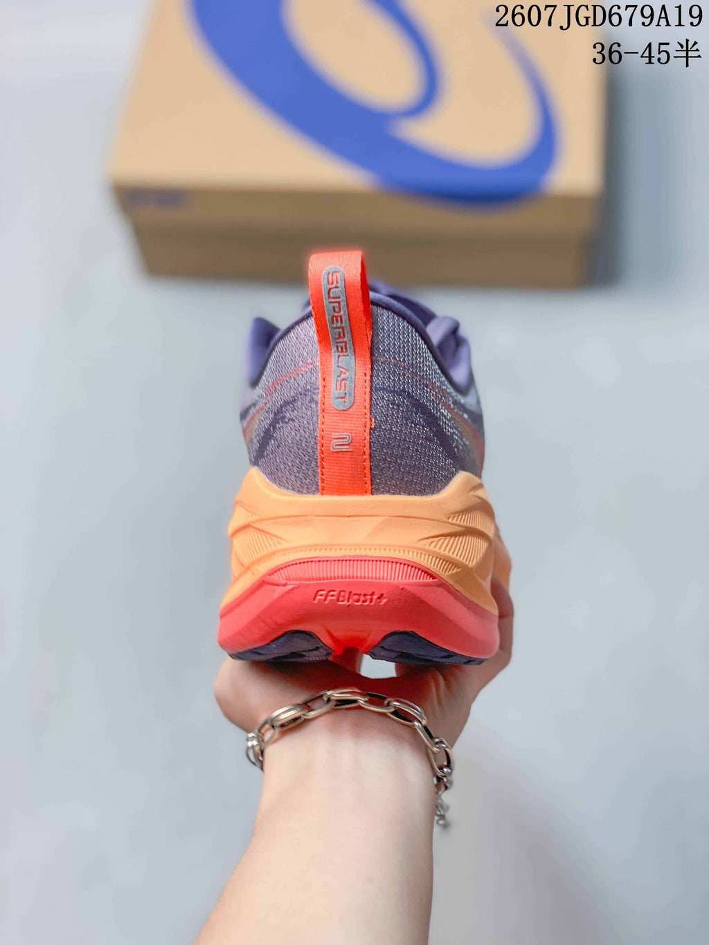 Rear view showing the orange heel pull tab, Superblast 2 branding, and layered midsole.
