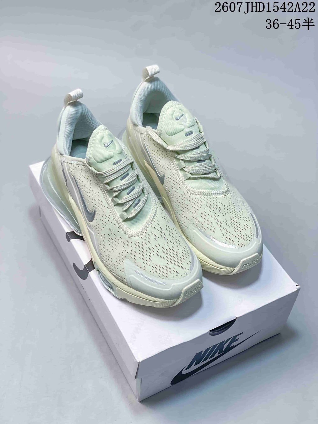 Pair of pale mint green Nike Air Max 270 Premium sneakers displayed on a Nike shoe box.