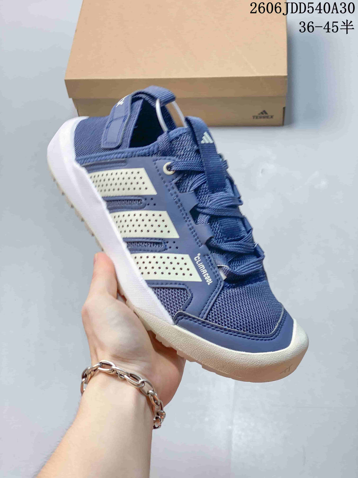 Navy Adidas Terrex Daroga 25 sneaker shown from the side.