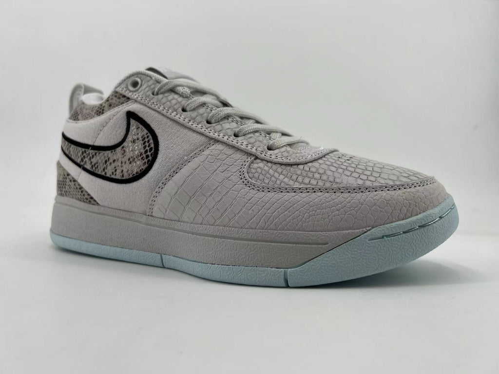 Opposite side and front angle of the gray Nike Book 1 sneaker