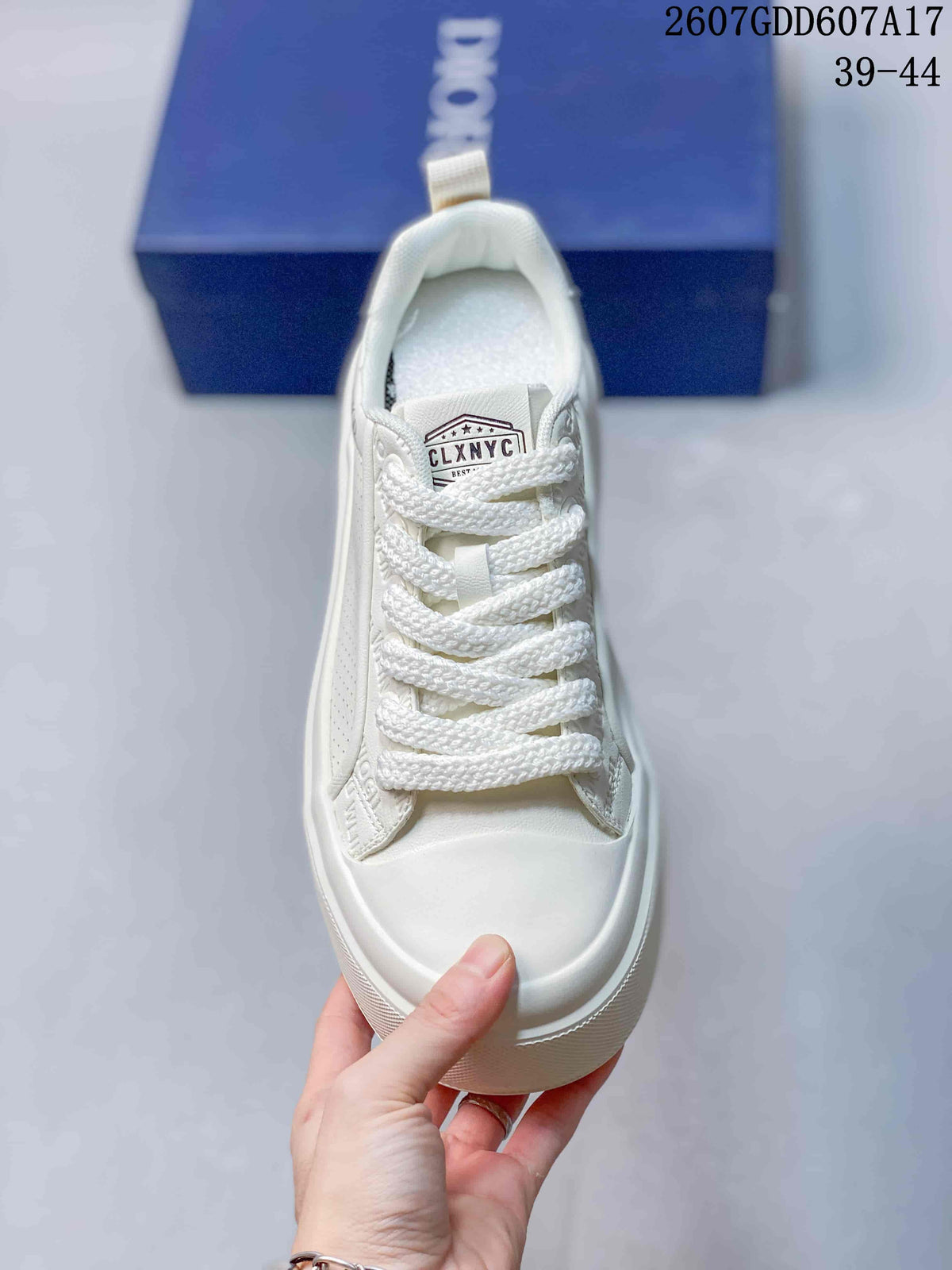 Top view of the white lace-up sneaker showing the tongue label, braided laces and rounded toe.
