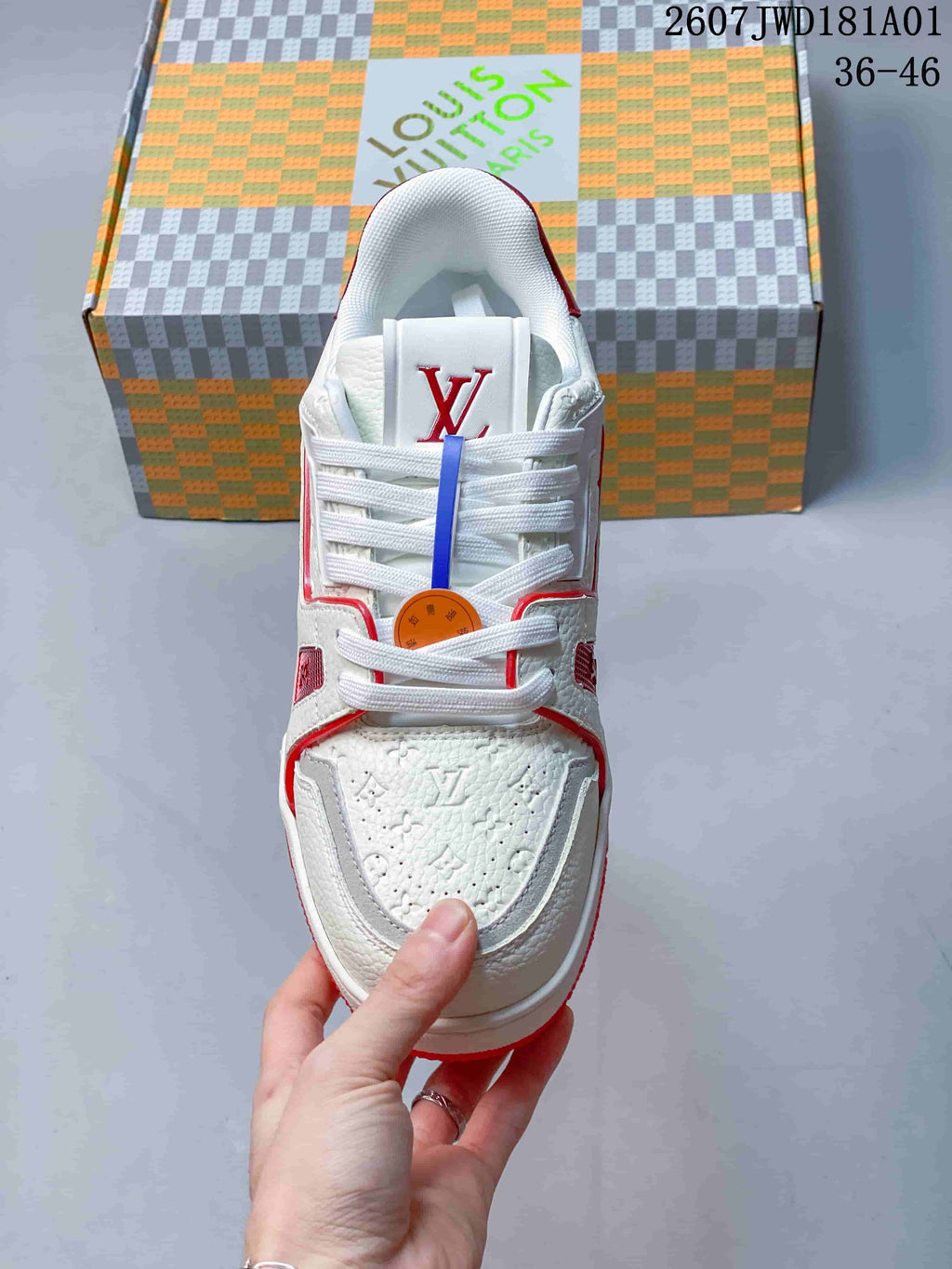 Top view of the white lace-up sneaker with red accents