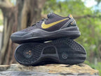 Side view of one sneaker above the other, clearly showing the patterned outsole tread and gold accents.
