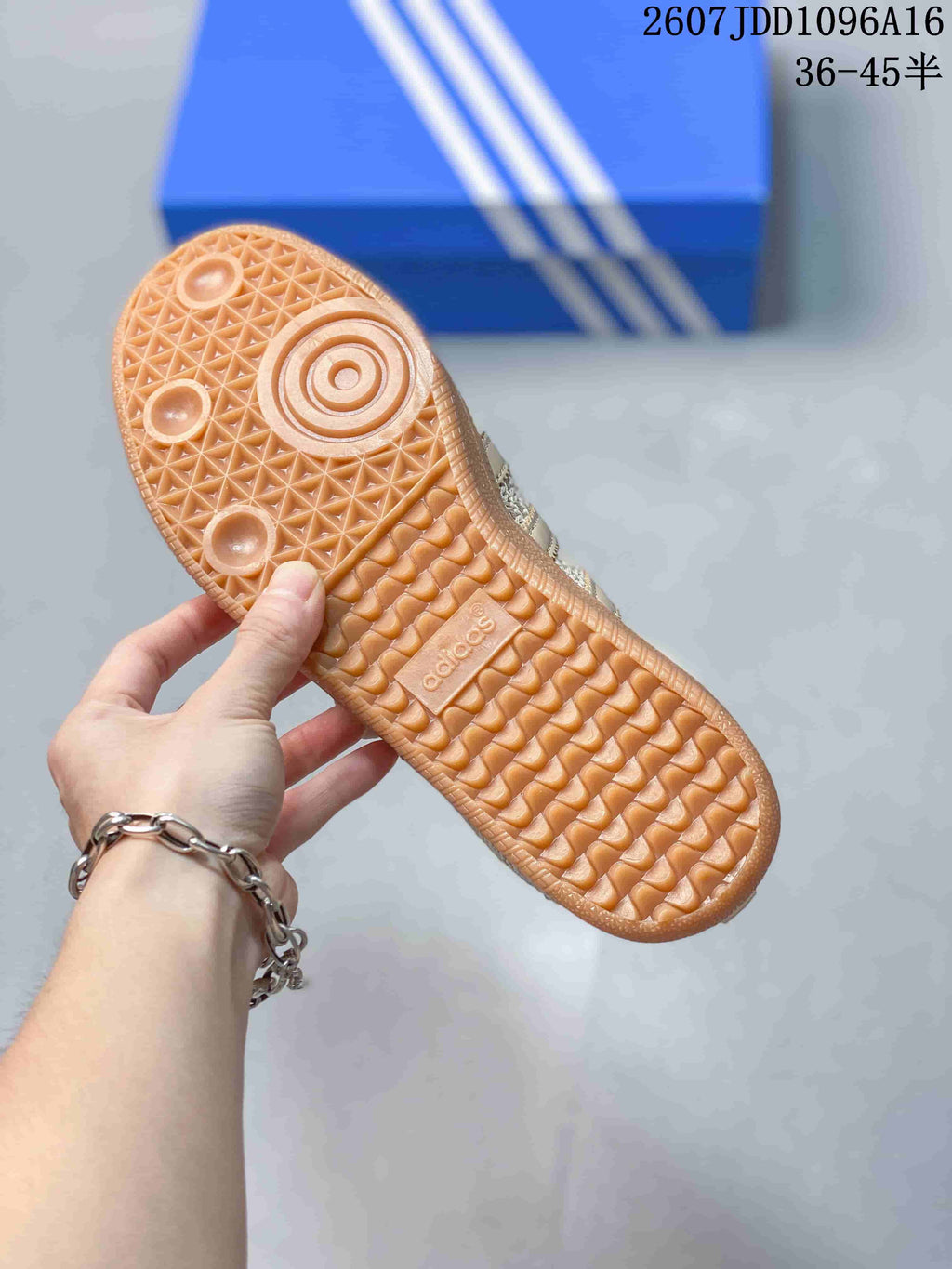 Close-up of the gum-colored outsole showing its geometric tread pattern and Adidas branding.