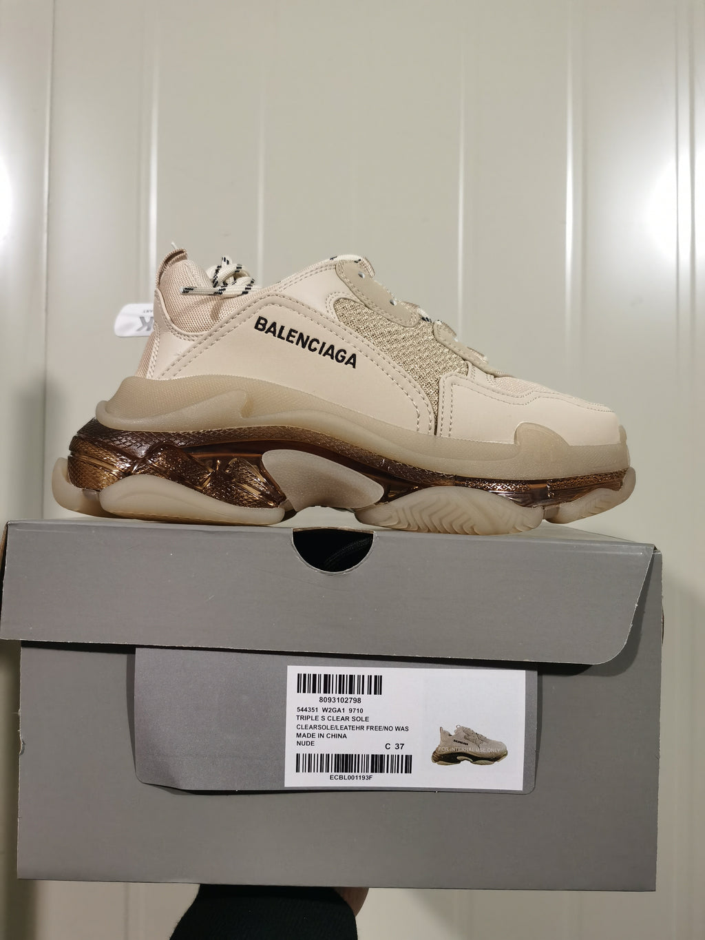 Balenciaga Triple S sneaker displayed on its box, with the box label showing style code 544351 W2GA1 9710, Triple S Clear Sole, color Nude, and a photographed size marked C 37.