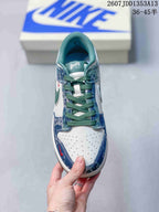 Top view showing green laces, a perforated white toe box and blue patterned surrounding panels.