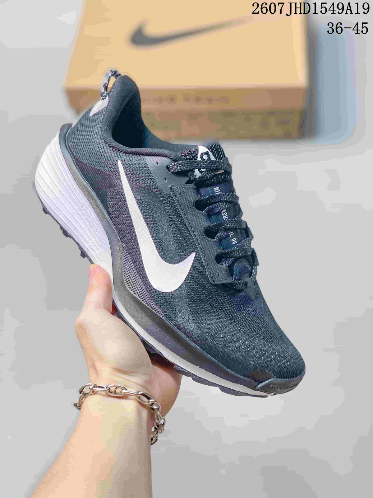 Dark charcoal Nike Zoom Fly 5 sneaker with a white Swoosh and white layered sole.