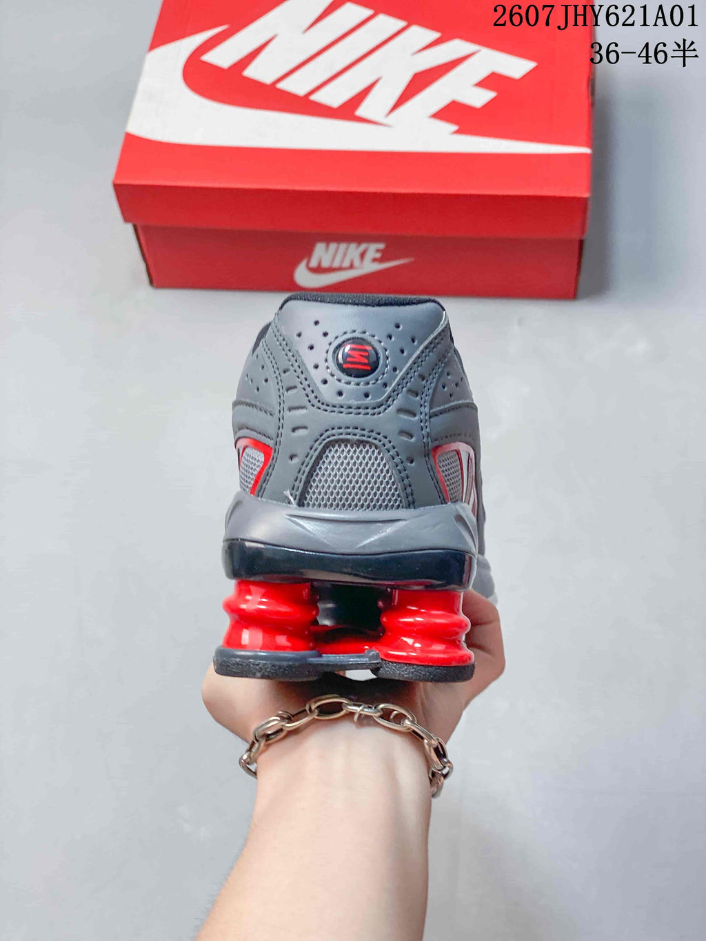 Rear view of the grey and red Nike Shox Ride 2 sneaker with heel columns