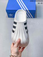 Top view of the white mule clog showing its ridged upper and black stripe details
