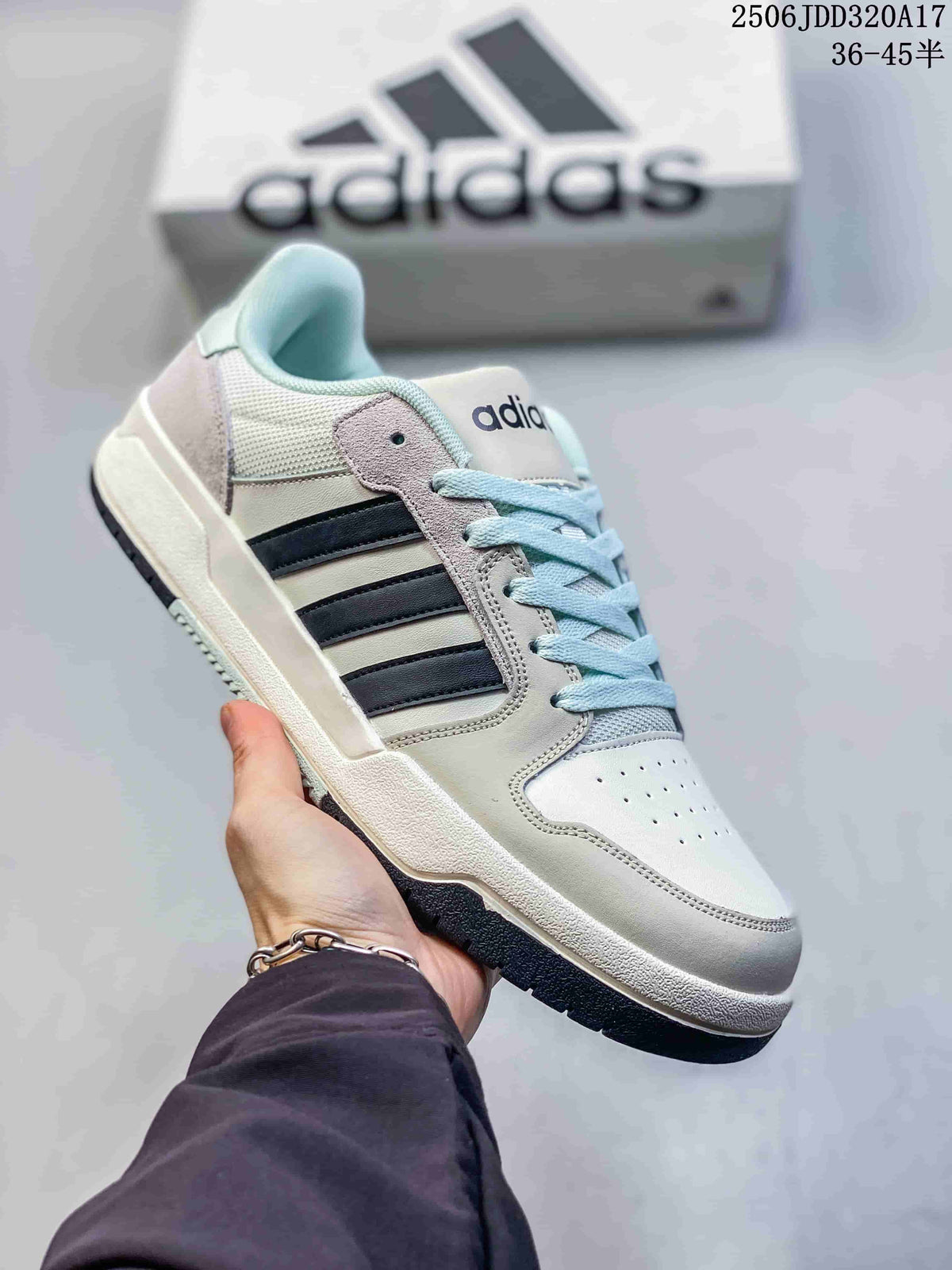 White adidas Entrap sneaker with black side stripes, light blue laces and a dark outsole.