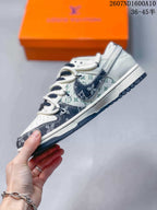 Side profile showing the white and navy upper, patterned overlays, contrasting Swoosh detail, and layered sole.