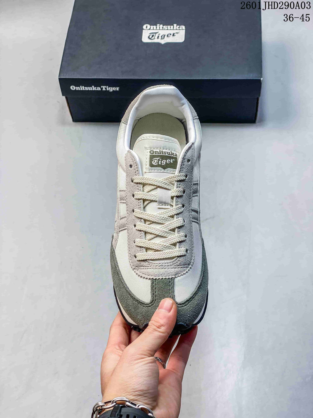 Top view of the sneaker showing cream laces, the branded tongue label, and gray-green toe overlays.