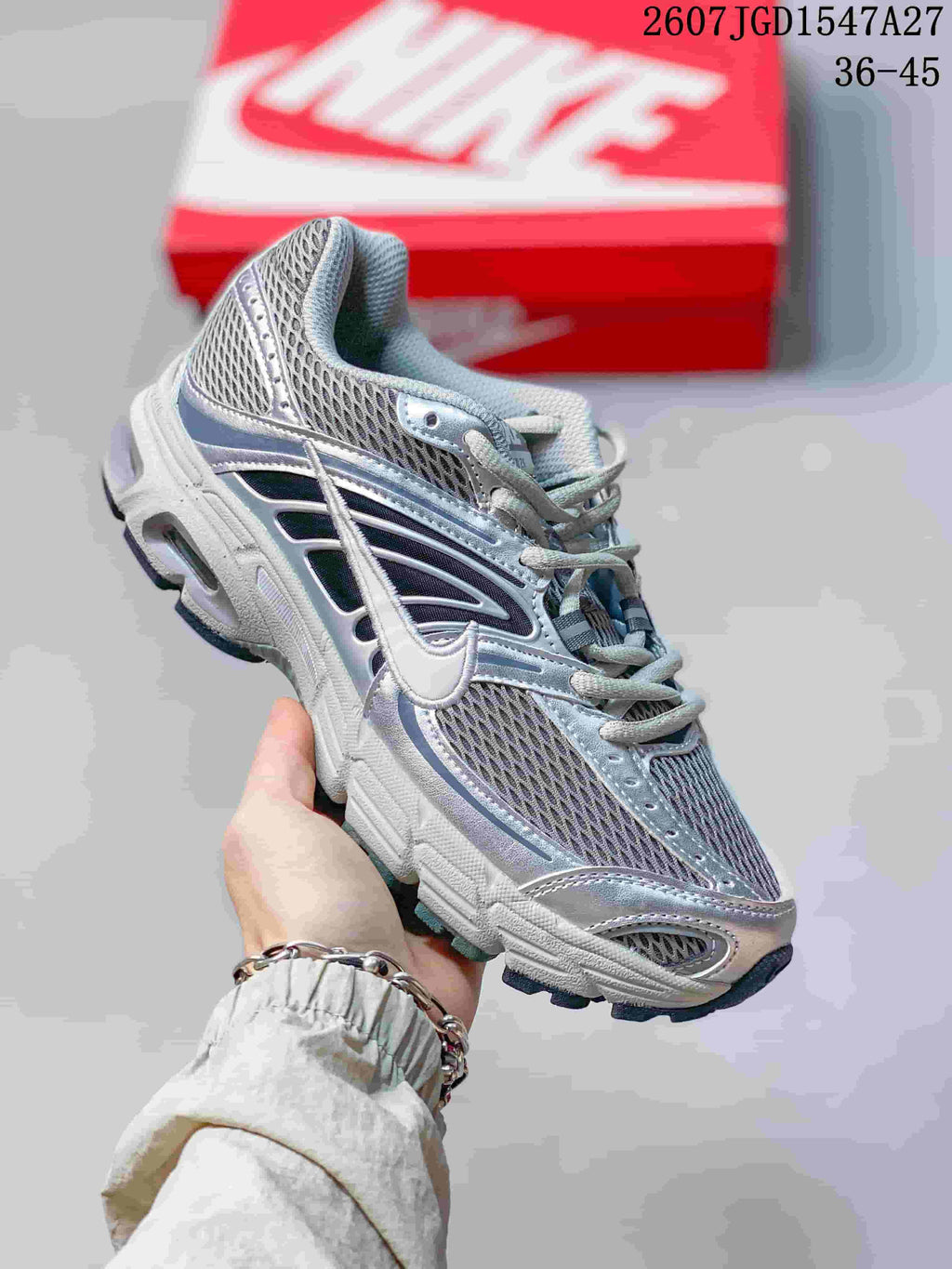 Angled side view of the Nike Air Max Moto 2K sneaker with mesh construction and layered side detailing.