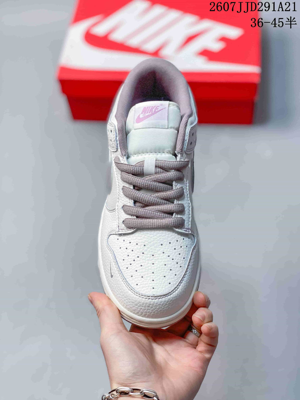 Top view showing the perforated white toe box, gray laces, tongue label, and padded collar.