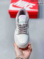 Top view showing the perforated white toe box, gray laces, tongue label, and padded collar.