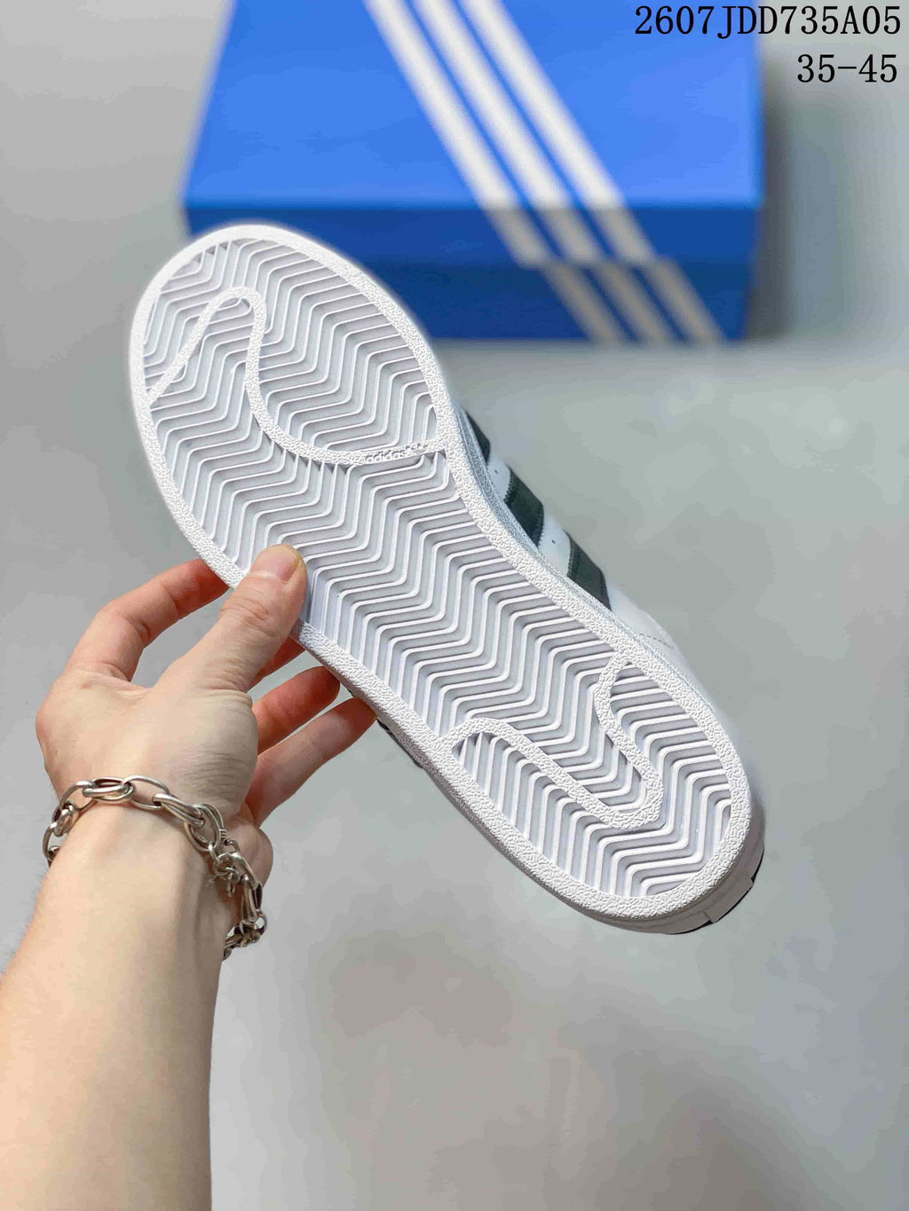 Close view of the sneaker outsole showing a white herringbone tread pattern.
