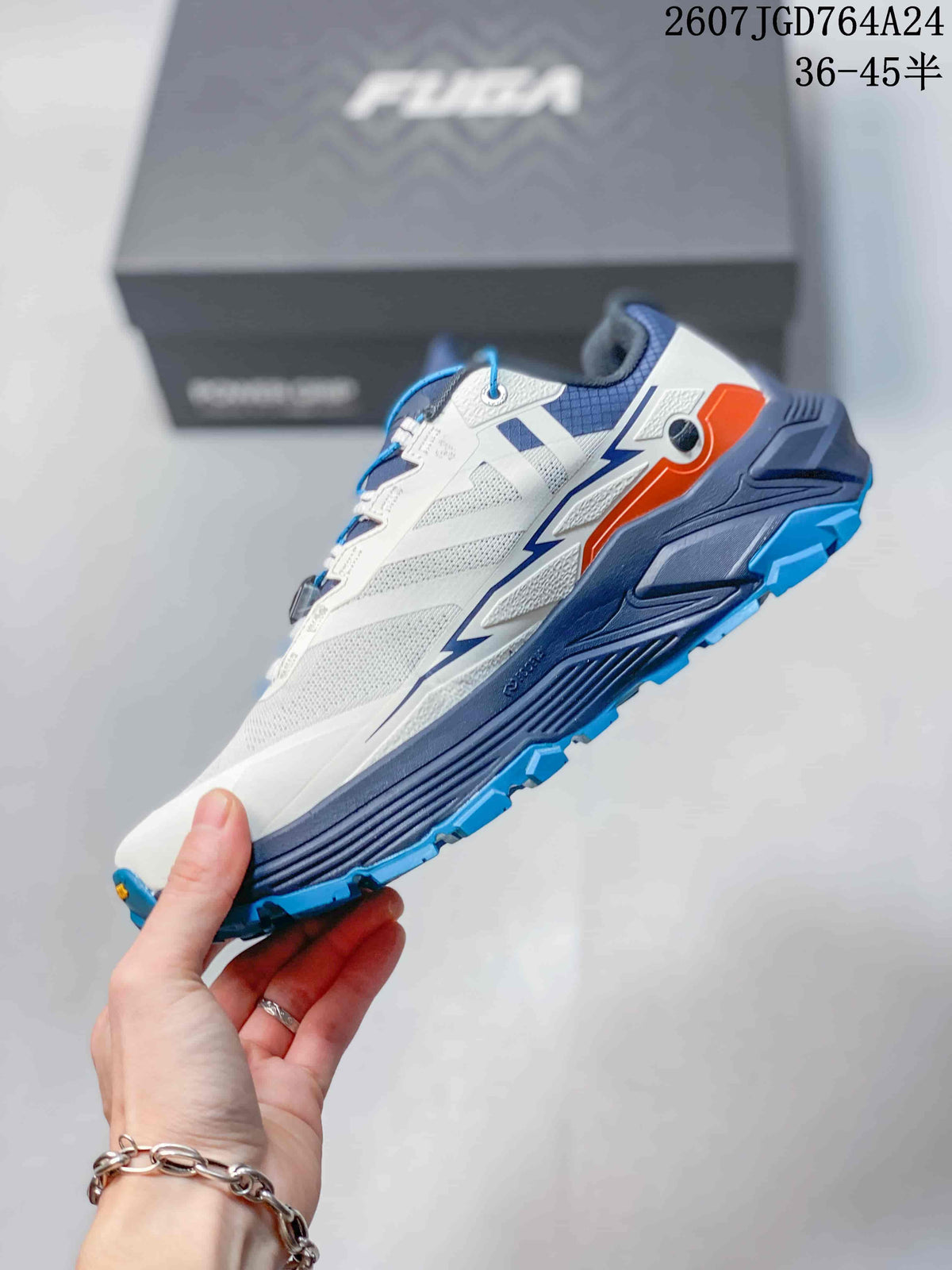 Side view showing the white and navy low-top trail shoe with orange detailing and a blue lugged outsole.