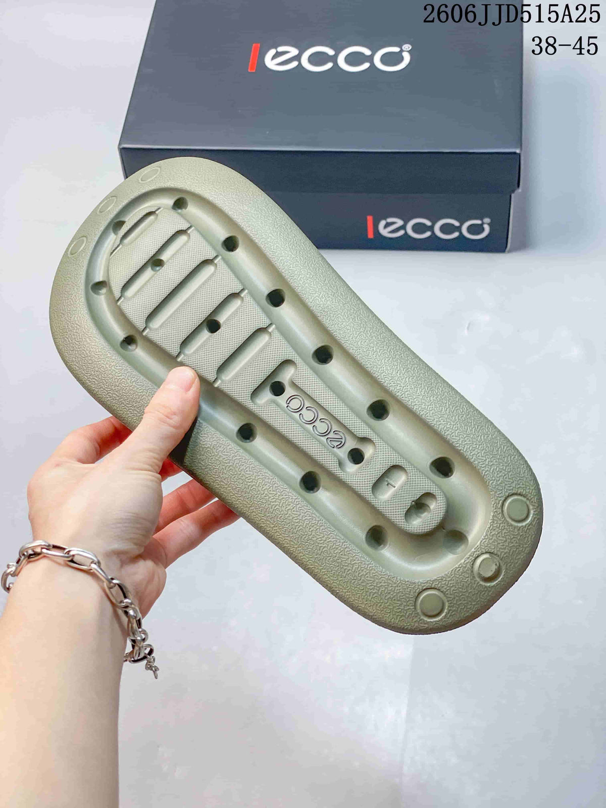 Bottom view of an olive-tan sandal showing the molded outsole, drainage-style openings, and ECCO branding.